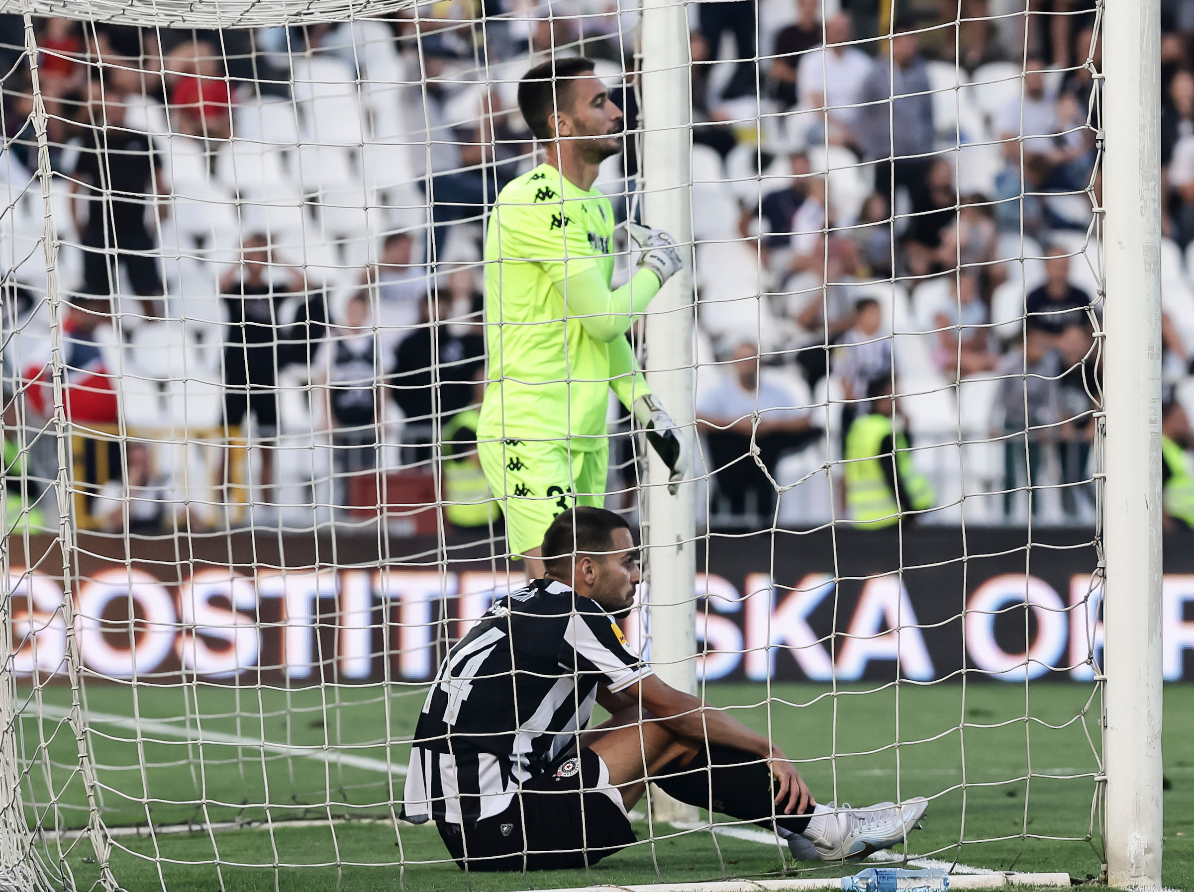 Stefan Milic (L) and goalkeeper Milos Krunic of Partizan react during the Mozz