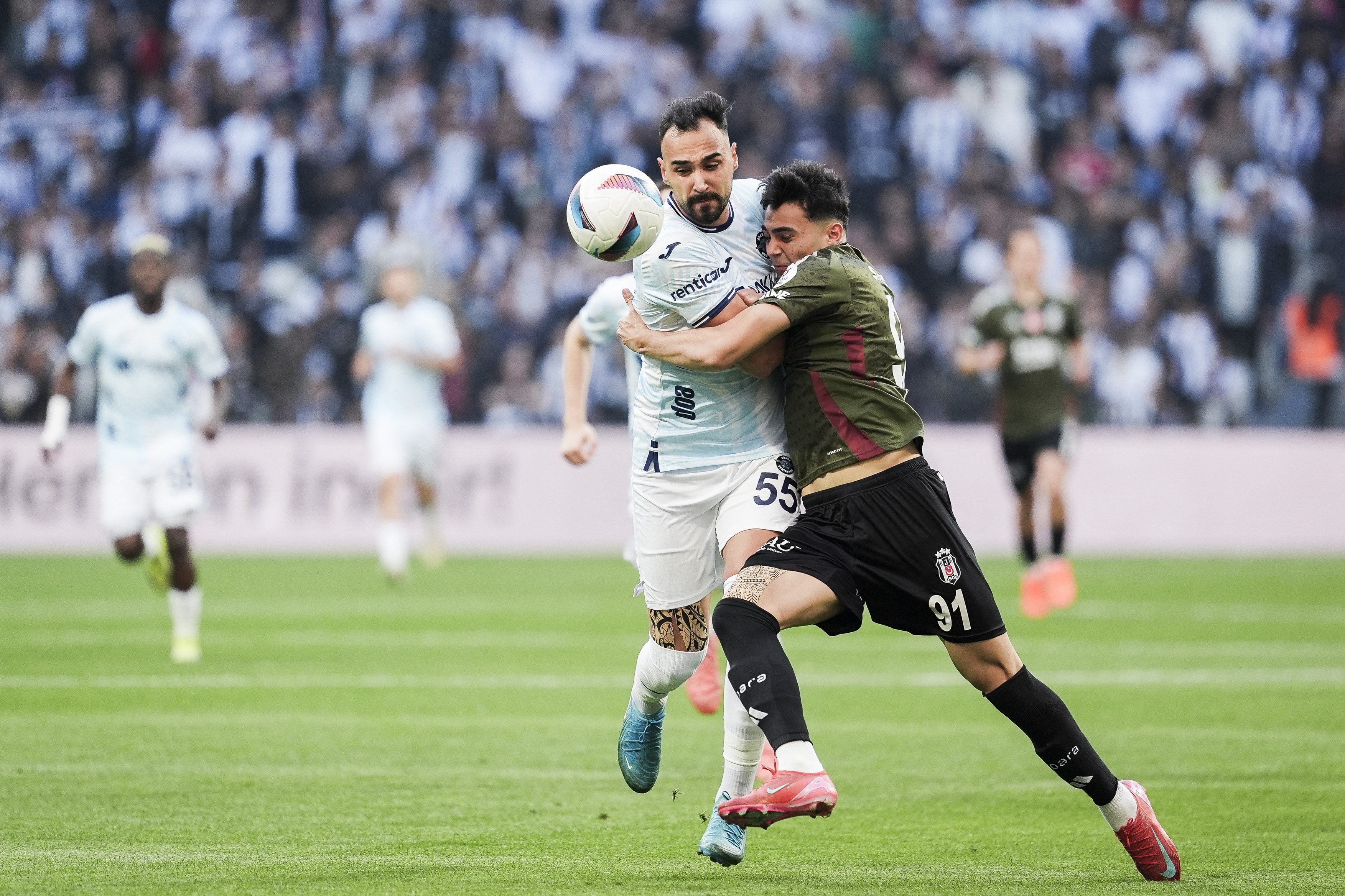 Mustafa Hekimoglu (R) of Besiktas in action against Tolga Kalender (L) of Adana Demirspor