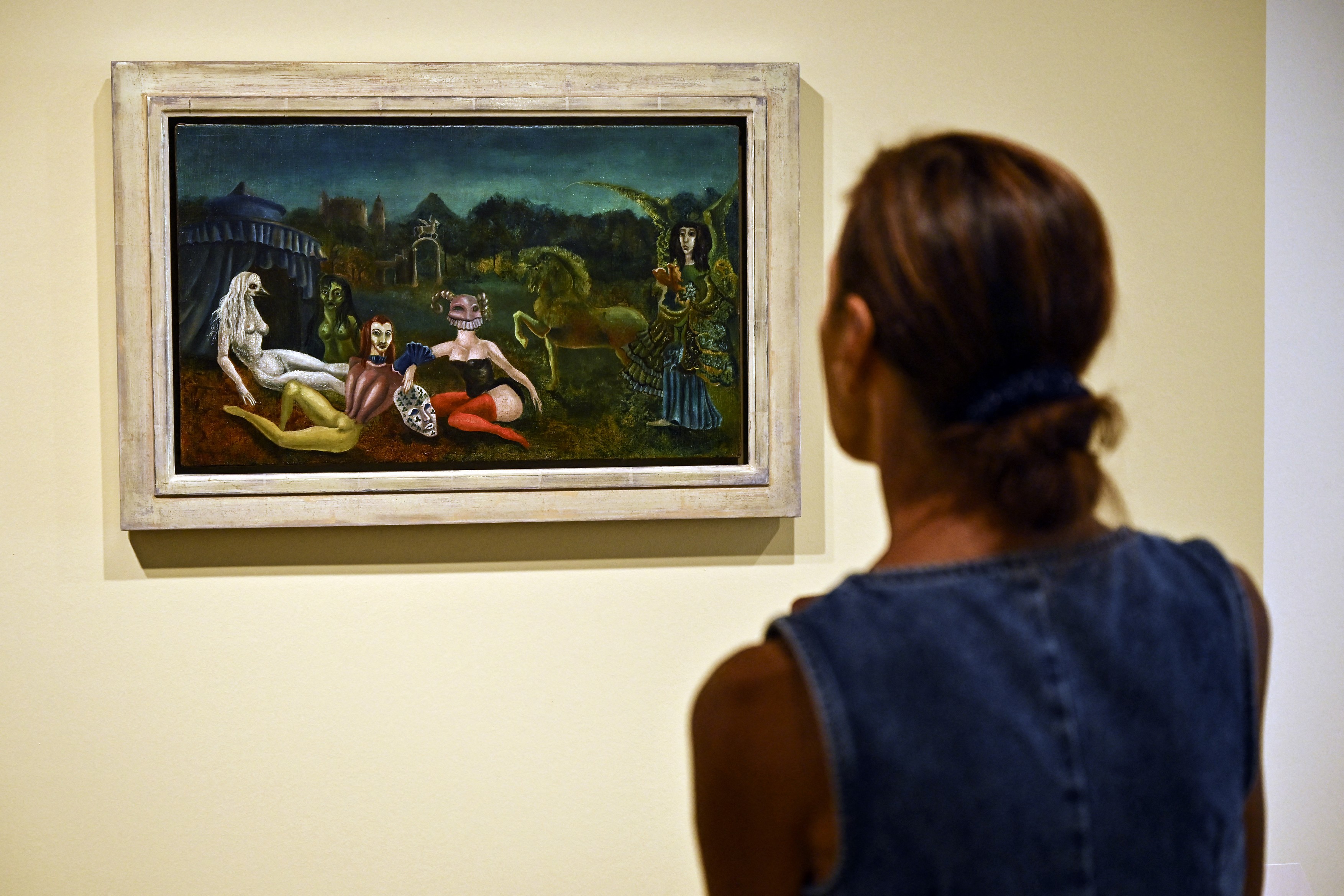 A visitor looks at British-Mexican artist Leonora