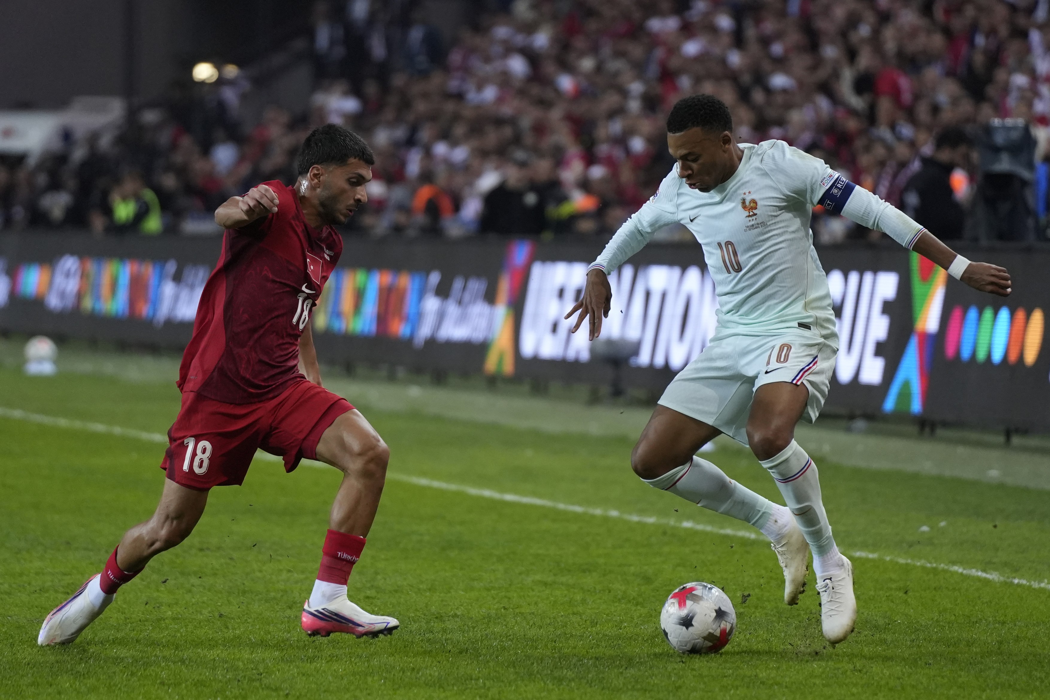 Kylian Mbappe (R) of France in action against Oguz Aydin (L) of Turkey