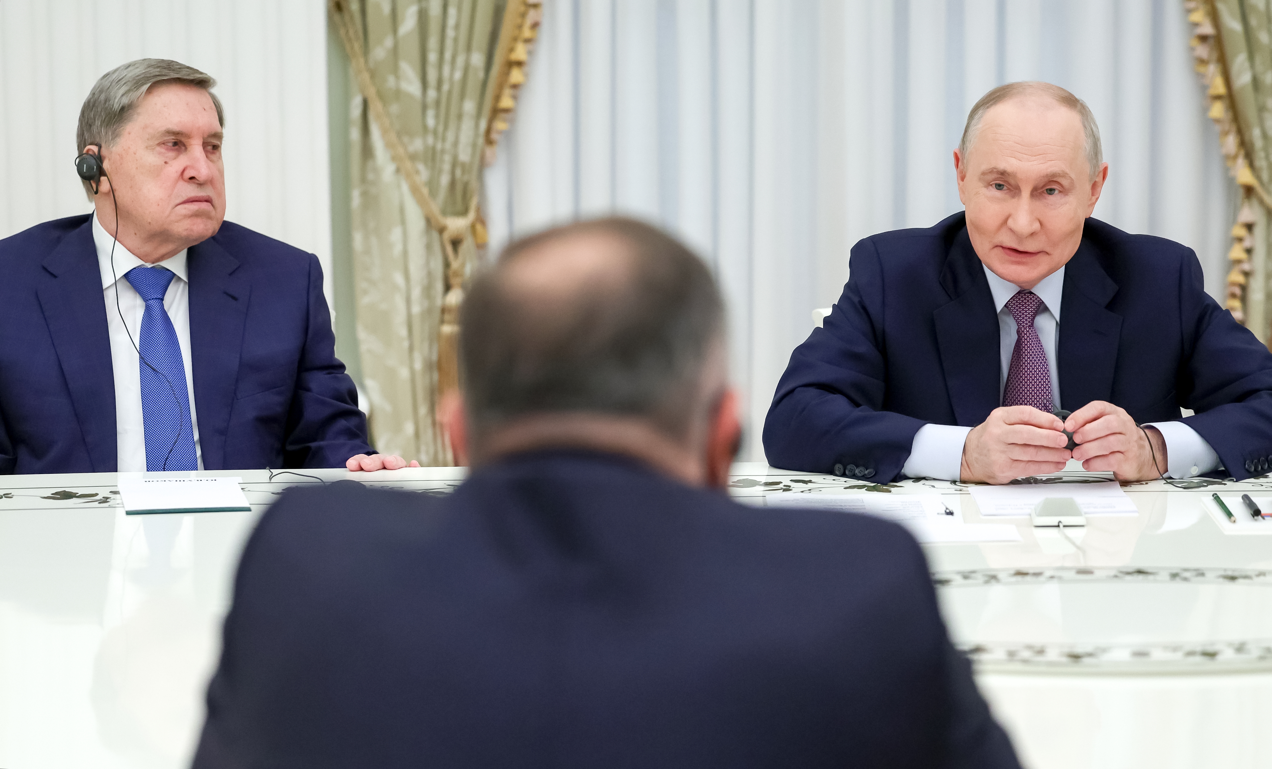epa13271033 Russian President Vladimir Putin (R) and Russian Presidential Aide Yury Ushakov (L) attend a meeting with Prime Minister of Republika Srpska Savo Minic and Leader of Republika Srpska's Alliance of Indep