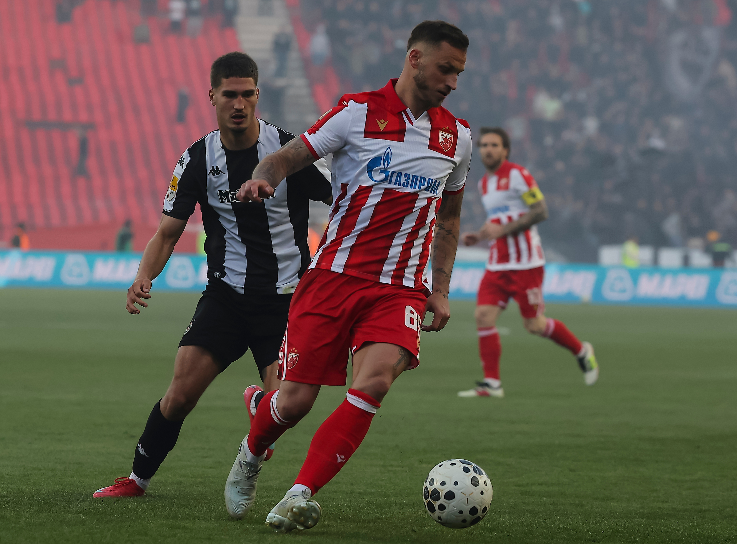 Marko Arnautovic (R) of Crvena Zvezda in action against Nikola Simic of Partizan