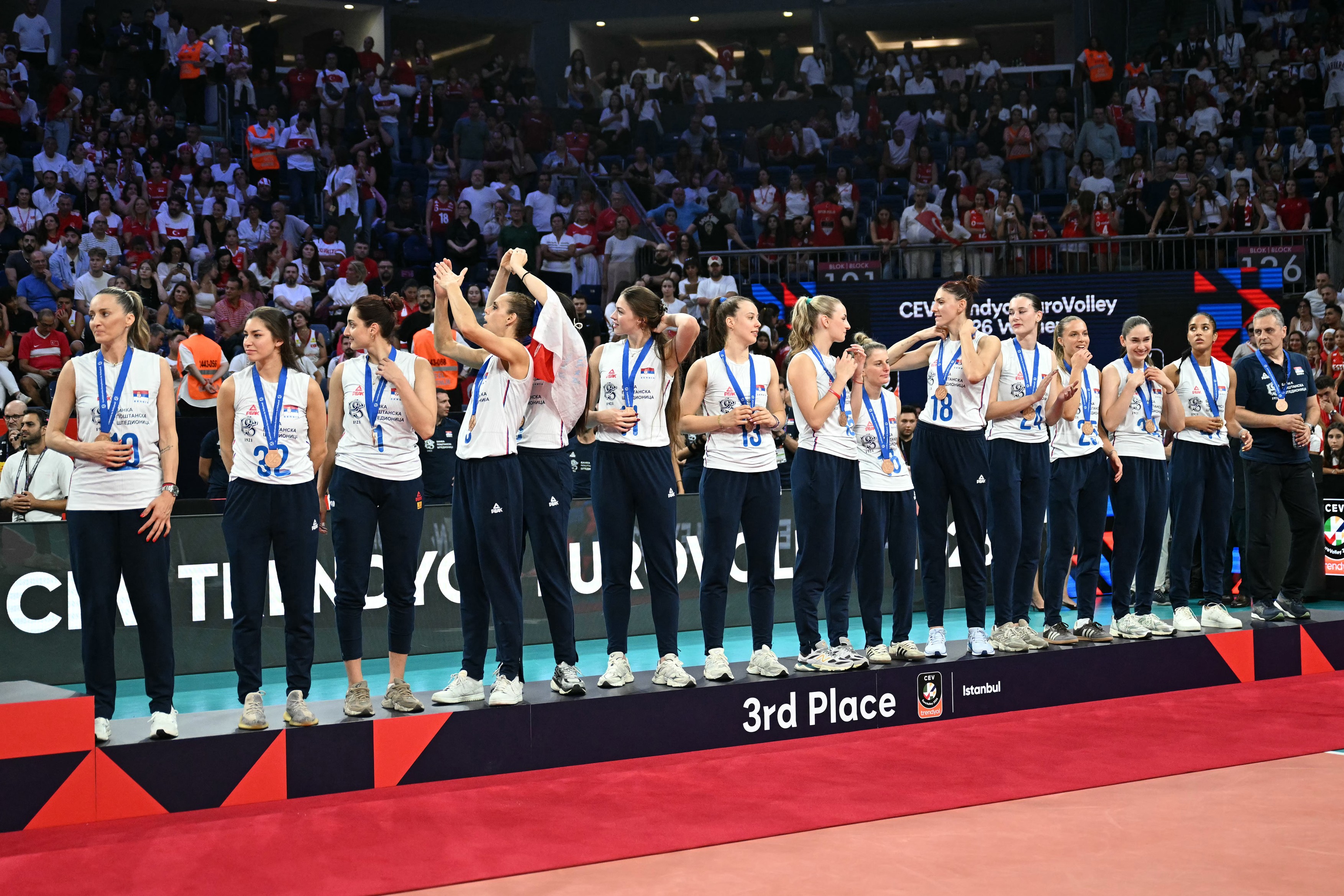 Serbia's players react on the podium after receiving their bronze medals