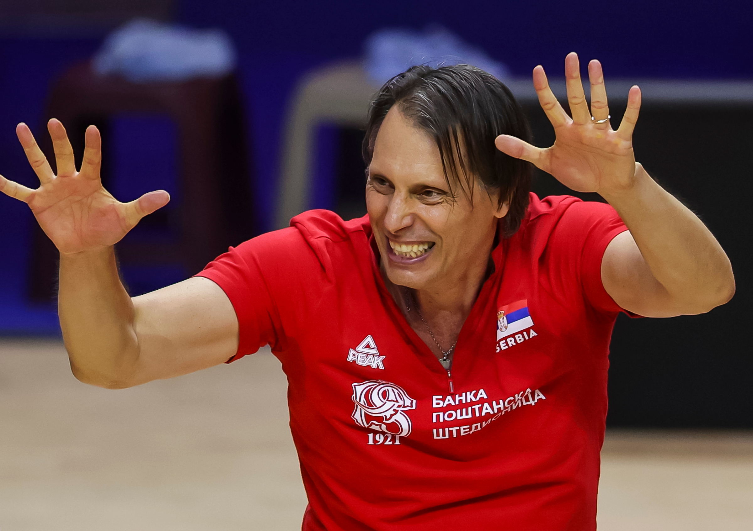Serbia's head coach Gheorghe Cretu (C) celebrates after winning