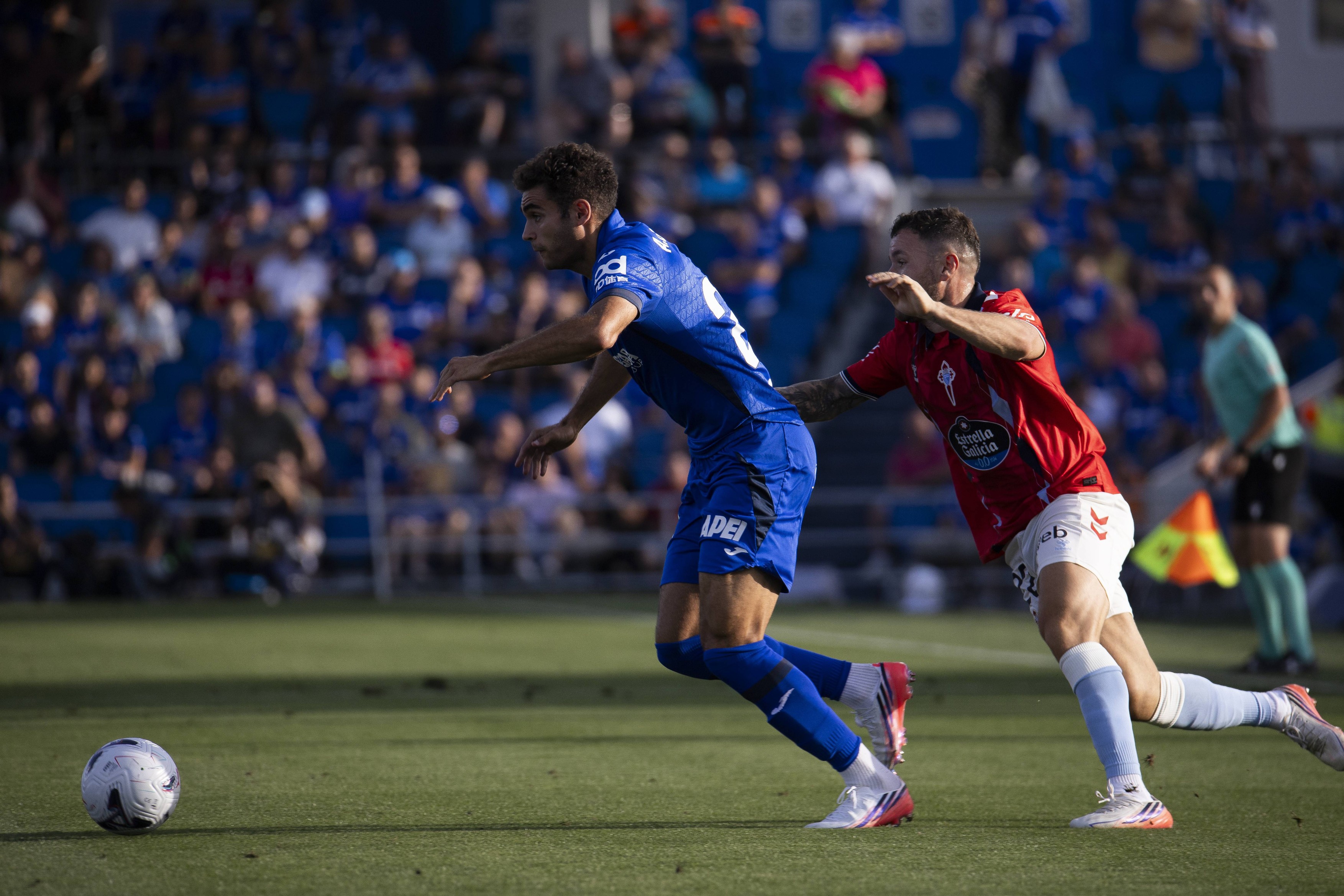 Andres Garcia Robledo of Getafe is defended by Javi Galan during La Liga EA Sports match between Getafe and Celta de Vigo at Estadio Coliseum