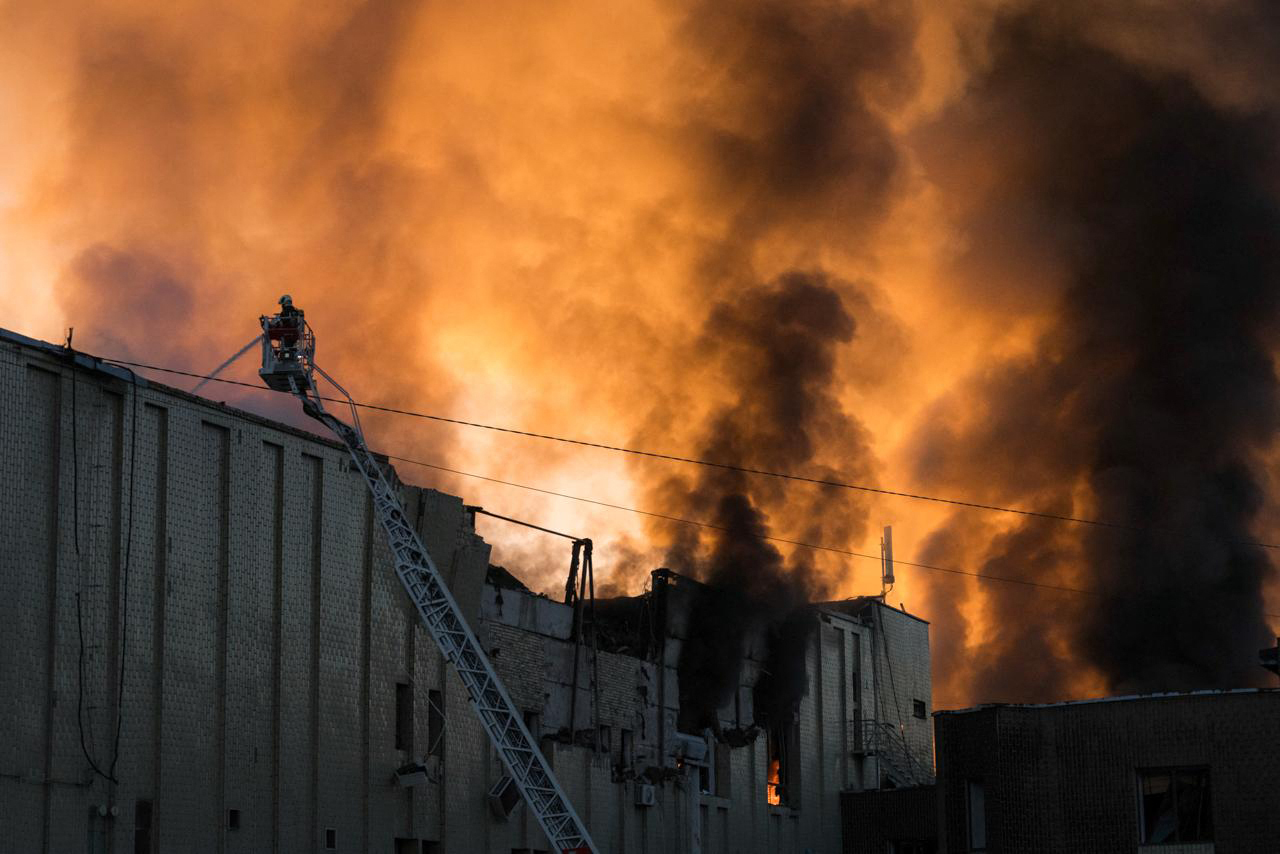 Firefighters are at work to push out a fire following Russian missiles strikes in Kyiv