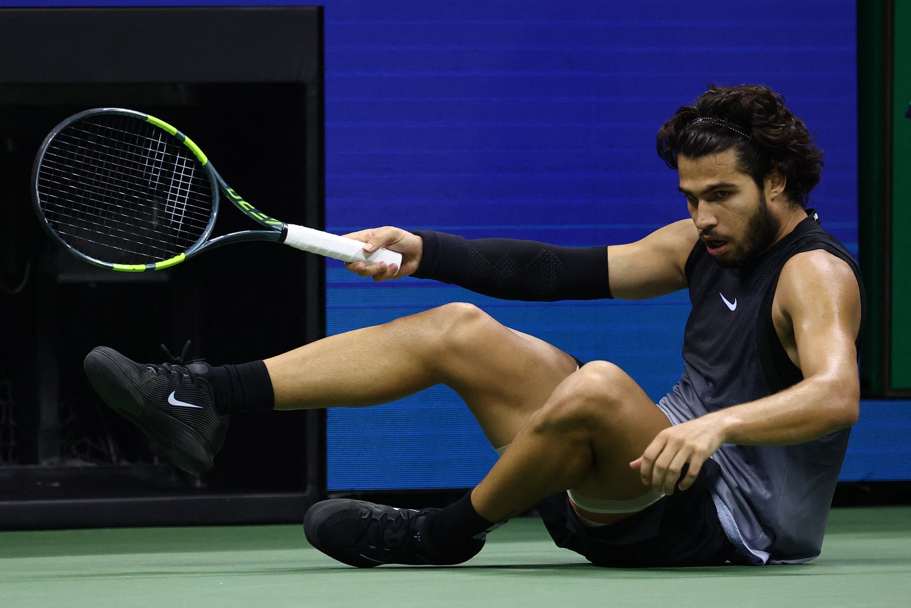 Spain's Carlos Alcaraz falls during the men's singles quarter-final tennis